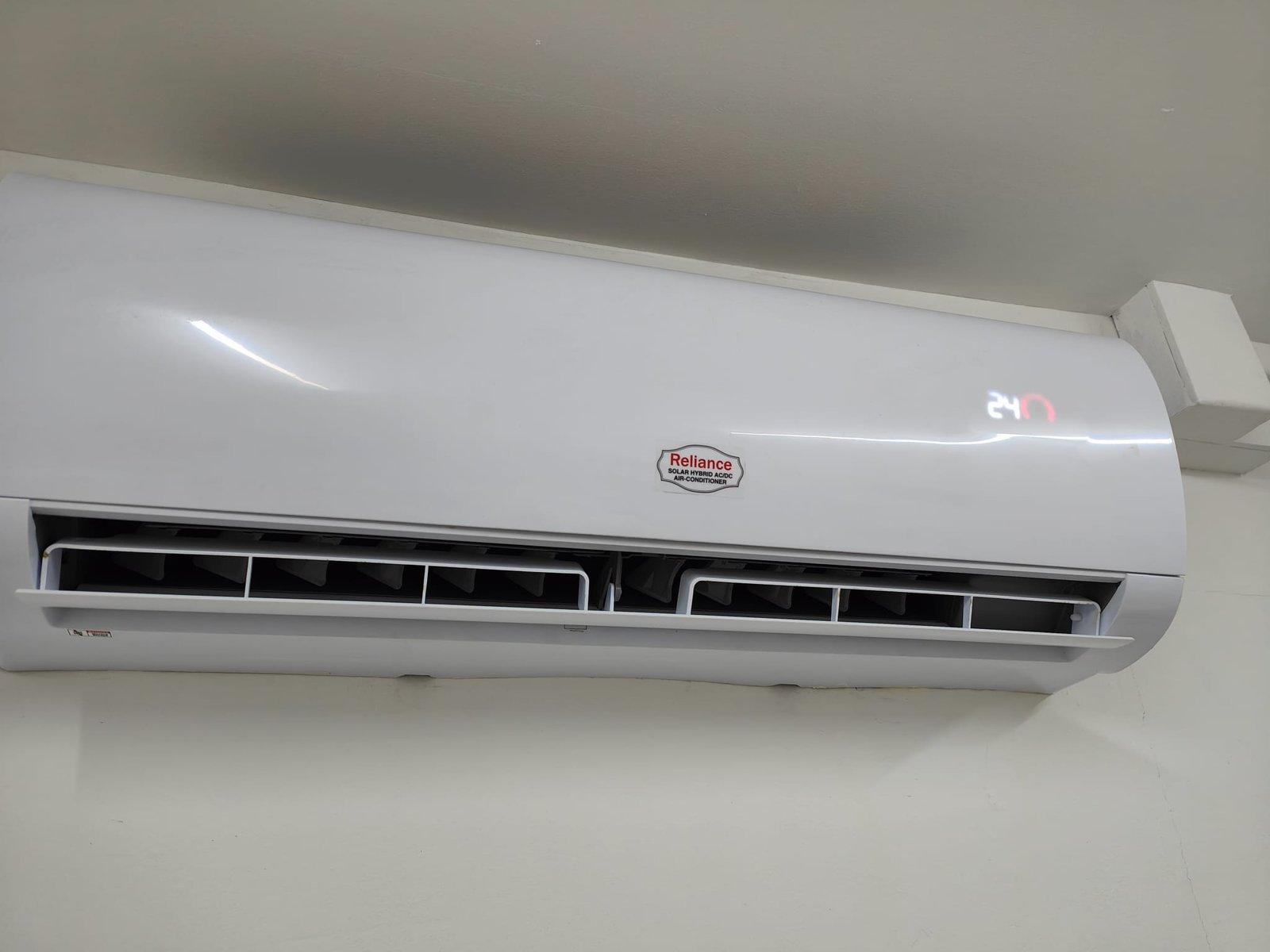 A technician installing an outdoor solar air conditioner unit